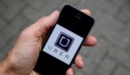 A photo illustration shows the Uber app logo displayed on a mobile telephone as it is held up for a posed photograph in central London, Britain, October 28, 2016. Reuters/Toby Melville