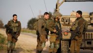 Israeli soldiers stands near a military jeep next to the border fence with the southern Gaza Strip near Kibbutz Nirim, Israel February 17, 2018. REUTERS/Amir Cohen