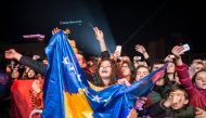 Kosovo's Albanians wave Kosovo flag during a concert by Kosovo-born British singer and actress Rita Ora in Pristina on February 17, 2018 on the occasion of the 10th anniversary of Kosovo Independence. AFP / Armend Nimani 
