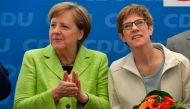 (FILES) This file photo taken on March 27, 2017 shows German Chancellor Angela Merkel (L) applauding Annegret Kramp-Karrenbauer after she won regional elections in the southwestern federal state of Saarland, during a meeting with the leadership of their c