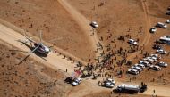 Iranian rescue teams gathering in the area of a search operation for the wreckage of a plane that crashed near a mountain peak two days earlier in Iran's Zagros mountain range.  AFP /Mohammed KHADEMOSHEIKH
