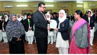 Ideal Indian School Principal Syed Shoukath Ali handing hall tickets to students. 
