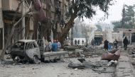 Damaged buildings and a vehicle are seen after Assad regime forces carried out airstrikes over the de-escalation zone in Arbin town of Eastern Ghouta in Damascus, Syria on February 23, 2018. Qusay Noor - Anadolu
