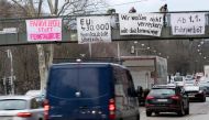 Protesters on a bridge hold banners to protest against particulate pollution as vehicles drive on a busy road on February 1, 2018 at a traffic junction of the Neckartor roadway, a Stuttgart neighbourhood which is a hotspot for air pollution. The banner (C
