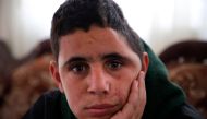 Palestinian Mohammed al-Tamimi, 15, poses for a picture at his family home in the West Bank city of Ramallah on February 27, 2018.  AFP / Abbas Momani