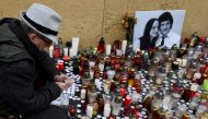 A man lights a candle for a tribute to murdered Slovak investigative reporter Jan Kuciak at Slovak National Uprising Square in Bratislava, Slovakia, February 27, 2018. REUTERS/Radovan Stoklasa