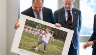 Russian Foreign Minister Sergei Lavrov (L) holds a picture next to Director-General of the United Nations Office at Geneva Michael Moller during the opening of a photo exhibition on disabled people entitled: 