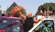 Amit Shah, president of the Bharatiya Janata Party (BJP), celebrates with supporters the state election results in three northeast states, outside the BJP headquarters in the Indian capital New Delhi on March 3, 2018.  / AFP / SAJJAD HUSSAIN
