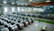 File picture of a worker walking through a warehouse at the Han-steel plant in Handan in China's northern Hebei province, April 21, 2016.  / AFP / WANG ZHAO