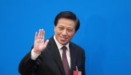 Zhang Yesui, the spokesperson of China's National People's Congress, waves during a press conference at the Great Hall of the People in Beijing on March 4, 2018. AFP / Nicolas Asfouri 