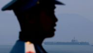 A Vietnamese soldier keeps watch in front of US aircraft carrier USS Carl Vinson after its arrival at a port in Danang, Vietnam March 5, 2018. Reuters/Kham