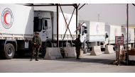 Russian soldiers are seen securing Syrian Arab Red Crescent trucks carrying aid at a checkpoint near Wafideen camp in Damascus, Syria March 5, 2018. REUTERS/Omar Sanadiki