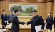 North Korean leader Kim Jong Un shakes hands with Chung Eui-yong who is leading a special delegation of South Korea's President, in this photo released by North Korea's Korean Central News Agency (KCNA) on March 6, 2018. KCNA/via Reuters 