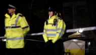 Police officers stand guard beside a cordoned-off area, after former Russian military intelligence officer Sergei Skripal, who was convicted in 2006 of spying for Britain, became critically ill after exposure to an unidentified substance, in Salisbury, so