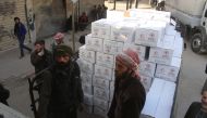 People organize the United Nations' aid boxes after United Nations' aid convoy enters the Douma town of Eastern Ghouta after Assad Regime stopped the assaults in Damascus, Syria on March 05, 2018. (Ammar Sab - Anadolu Agency)