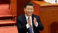 Chinese President Xi Jinping applauds after the parliament passed a constitutional amendment lifting presidential term limits, at the third plenary session of the National People's Congress (NPC) at the Great Hall of the People in Beijing, China March 11,