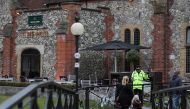 A police officer stands in front of The Mill pub in Salisbury, southern England, on March 11, 2018, as investigations continue in connection with the major incident sparked after a man and a woman were apparently poisoned in a nerve agent attack a week ag