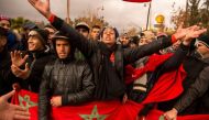 Moroccans shout slogans and wave the national flag during a demonstration in the northeastern city of Jerada on December 27, 2017 (AFP) 