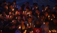 Nepali people take part in a candlelight vigil in honour of the plane crash victims in Kathmandu on March 13, 2018, a day after the deadly crash of a US-Bangla Airlines plane at the international airport. AFP / PRAKASH MATHEMA
