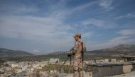 A member of Free Syrian Army, backed by Turkish Armed Forces is seen as he stands guard at Rajo’s town center on March 13, 2018.  Halil Fidan - Anadolu