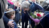 Britain's Prime Minister Theresa May (R) meets members of the public during her visit to Salisbury, southern England, on March 15, 2018, where she visited the areas where former Russian double agent Sergei Skripal and his daughter Yulia went to, and were 