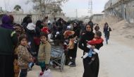 Syrians from the rebel-held Eastern Ghouta region, just outside Damascus, cross a regime-controlled corridor in Hamouria in Eastern Ghouta, after leaving the besieged enclave towards government areas on March 16, 2018. AFP
 
