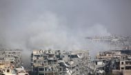 Smoke billows following Syrian government bombardment on the rebel-held besieged town of Harasta, in the Eastern Ghouta region on the outskirts of Damascus on March 12, 2018. AFP 
