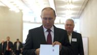 Russian President Vladimir Putin casts his ballot at a polling station during the 2018 Russian presidential election in Moscow, Russia on March 18, 2018.  Nataliy Zemboska - Anadolu 
