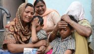 Indian resident Seema (L), her sons Karan (2R) and Arjun (2L) and her mother in-law Jeeto (R) react following confirmation by External Affairs minister Sushma Swaraj that her husband Sonu had been killed in Iraq in the village of Chawinda Devi some 22 kms