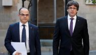 Catalan President Carles Puigdemont (R) walks with Catalan Government Presidency Councillor Jordi Turull as they arrive to hold a cabinet meeting at the regional government headquarters, the Generalitat, in Barcelona, Spain October 17, 2017. REUTERS/Gonza