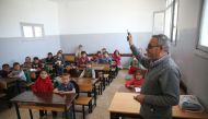 A teacher is seen with students during a lesson at a renovated school after it was damaged by YPG/PKK and Daesh terrorists within the 