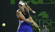 Caroline Wozniacki of Denmark hits a backhand against Monica Puig of Puerto Rico (not pictured) on day four of the Miami Open at Tennis Center at Crandon Park. Mandatory Credit: Geoff Burke-USA TODAY Sports