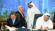 Sheikh Nasser bin Ali bin Saud Al Thani, Chairman of the World Trade Center Co. – Qatar, signs an MoU for promoting international commerce with Jian Zing Wii at Qatar Chamber headquarters. 