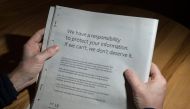 A man reads a full-page advertisement, taken out by Mark Zuckerberg, the chairman and chief executive officer of Facebook to apologise for the large-scale leak of personal data from the social network, on the backpage of a newspaper, in Ripon, England on 