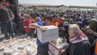 A member of Turkey's Disaster Management Agency (AFAD) distributes food and hygiene packages to Syrian families in Afrin, Syria after Turkish Armed Forces and Free Syrian Army (FSA) took complete control of northwestern Syria's Afrin within the 