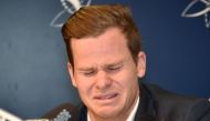 Cricketer Steve Smith reacts at a press conference at the airport in Sydney on March 29, 2018, after returning from South Africa.  AFP / PETER PARKS
