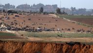 A picture taken on March 31, 2018, near the Israeli border with Gaza, shows Palestinian demonstrators gathering for a protest a day after clashes with Israeli forces on Land Day.  AFP / Ahmad Gharabli