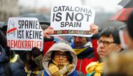 Protesters hold posters during a demonstration organised by the pro-independence association ANC (National Assembly of Catalonia) to demand the release of former Catalan regional president Carles Puigdemont who is detained in a prison in Germany, in Berli