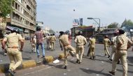 A Gujarat Police official (C) during clashes with members of the Scheduled Castes at a protest against a Supreme Court order that allegedly diluted the Scheduled Castes and Scheduled Tribes (Prevention of Atrocities) Act in Ahmedabad on April 2, 2018. AFP