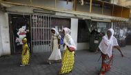 This file photo taken on September 2, 2017 shows Christian African Eritrean migrants walking outside at a makeshift church in southern Tel Aviv. (AFP / Menahem Kahana) 