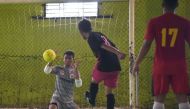 This picture taken on February 3, 2018 shows goalkeeper Eman Sulaeman (L) attempting a save during a futsal (five-a-side indoor football) match in Indramayu, West Java. AFP / Adek Berry 