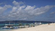 FILE PHOTO: Traditional boats line up the shore in a secluded beach on the island of Boracay, central Philippines January 18, 2016. REUTERS/Charlie Saceda/File Photo