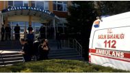 Turkish police officers and an ambulance stand at the entrance of Osmangazi University, on April 5, 2018, after a university employee killed four fellow staff members in a shooting, in the western Turkish city of Eskisehir. (AFP / DOGAN NEWS AGENCY / DHA)