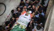 Palestinians carry the body of 23-year-old Palestinian Nabil al- Hadri who has been killed in Israeli airstrike during a funeral ceremony in Gaza City, Gaza on April 5, 2018. (Ali Jadallah / Anadolu Agency)