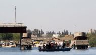 People cross the Euphrates River on a boat in Raqqa, Syria April 5, 2018.REUTERS/Aboud Hamam
