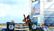 Qatar’s Bassem Mohammed guides Gunder over an obstacle during the event in Miami, USA.