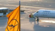 FILE PHOTO: A plane by Lufthansa is seen next to a Lufthansa flag at the international airport in Munich, Germany, January 9, 2018. REUTERS/Michaela Rehle
