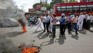 Activists of National Panther party burn tyres and shout slogans during a protest in support of various demands, including deportation of Rohingyas and Bangladeshi nationals from Jammu, and a CBI probe into the rape and murder of an eight-year-old girl in