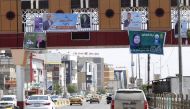 An image of the city of Basra shows campaign billboards for Iraqi candidates in the upcoming parliamentary elections, April 14, 2018. / AFP / HAIDAR MOHAMMED ALI 