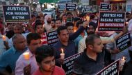 People hold candles and placards during a vigil, organised by the members of the Jammu and Kashmir High Court Bar Association, to show solidarity with the victim and demand a Central Bureau of Investigation (CBI) probe into the rape and murder of an eight